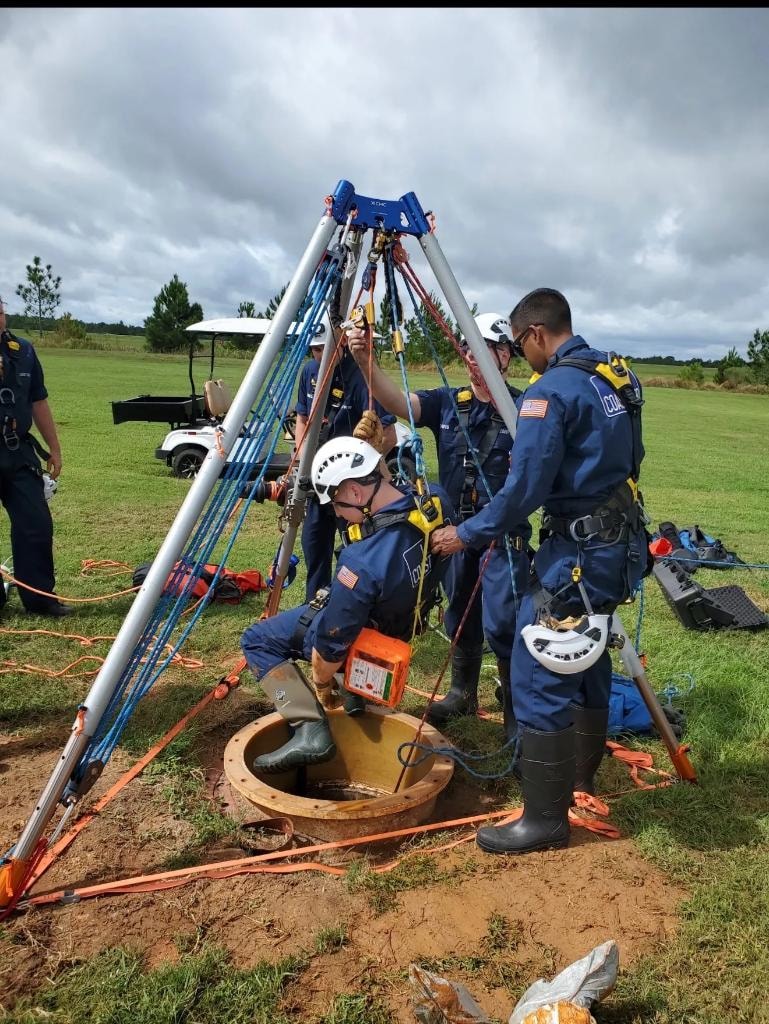 Technical rescue team working around a confined space tripod